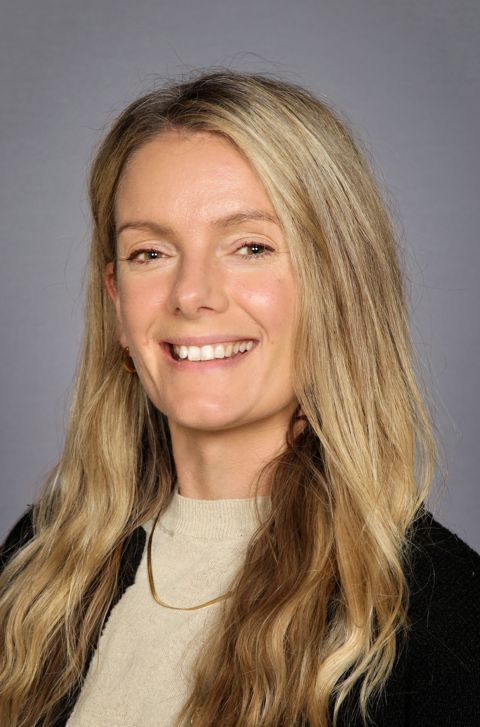 a woman with long hair smiling